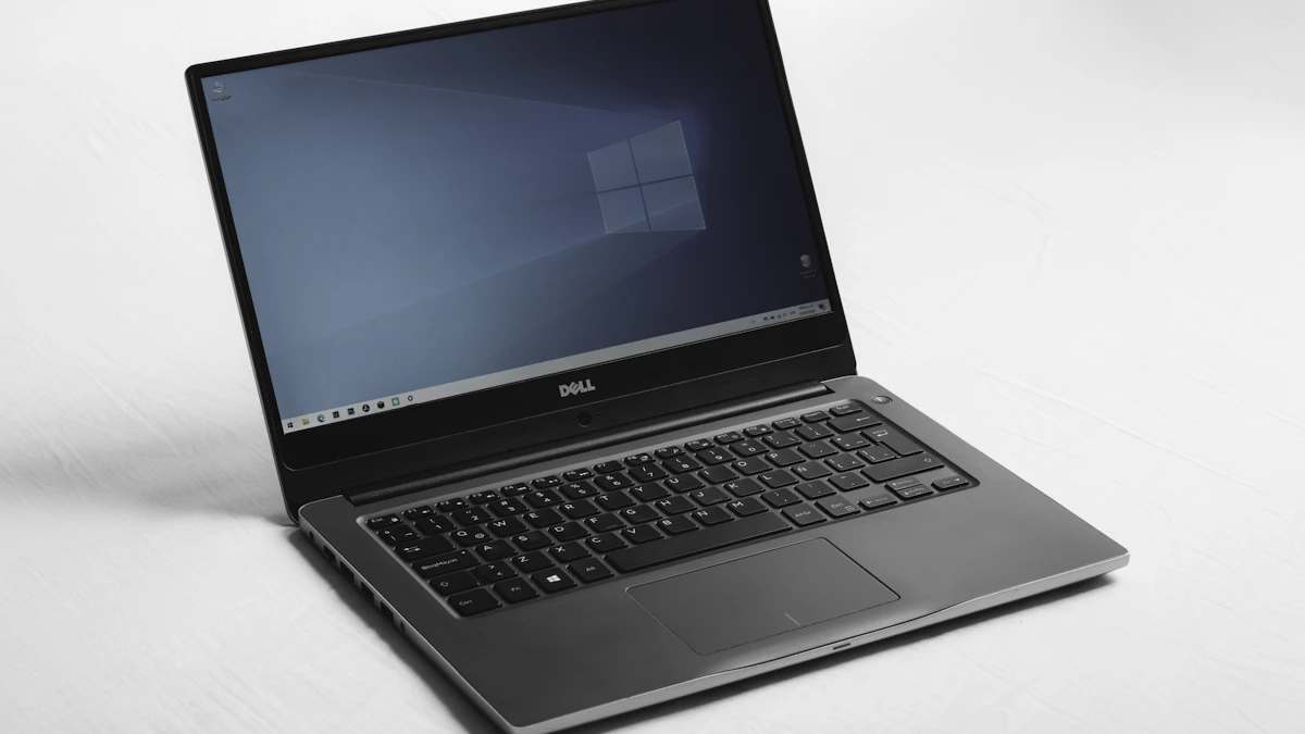 Open laptop being inspected on a technician’s bench